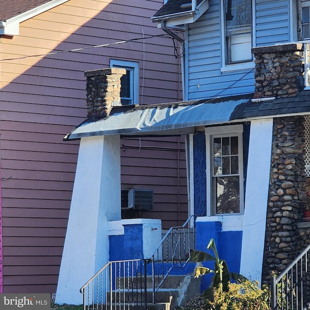 view of side of property featuring a wall mounted AC