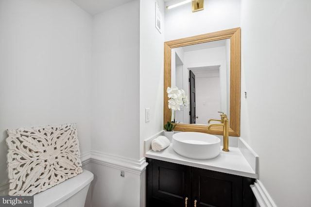 bathroom featuring vanity and toilet