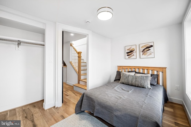 bedroom with hardwood / wood-style floors and a closet