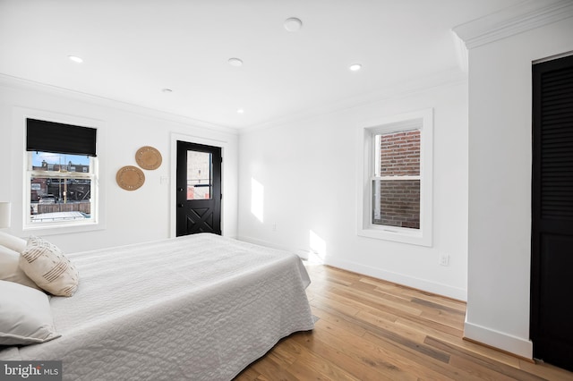 bedroom featuring hardwood / wood-style flooring and crown molding