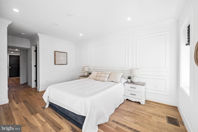 bedroom with crown molding and wood-type flooring