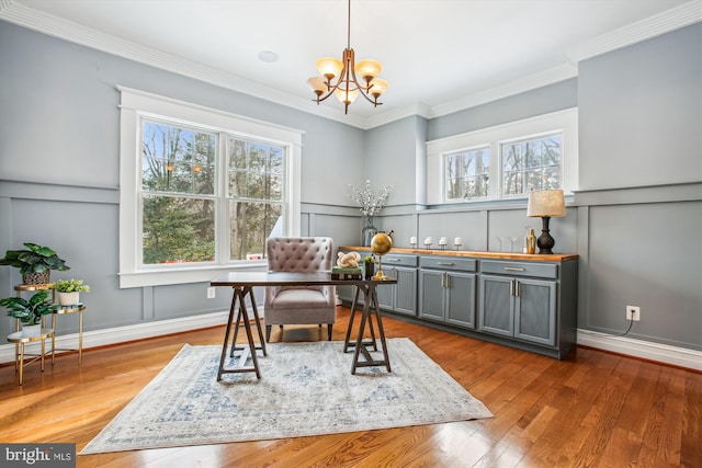 office featuring hardwood / wood-style floors, an inviting chandelier, and ornamental molding