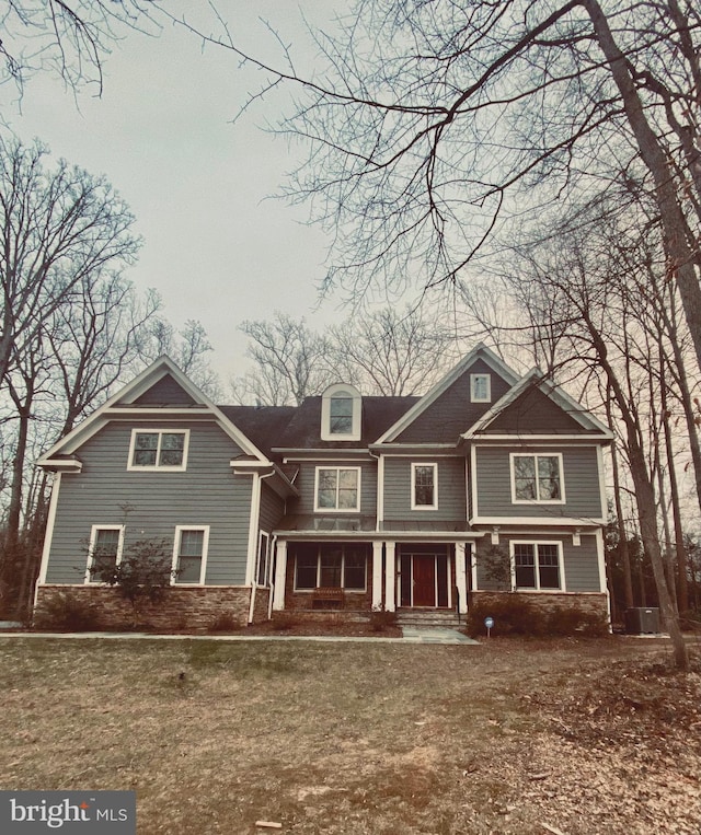 view of front of house featuring a porch and a front lawn