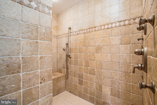 bathroom with a tile shower