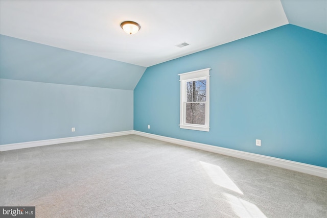 bonus room with carpet floors and vaulted ceiling