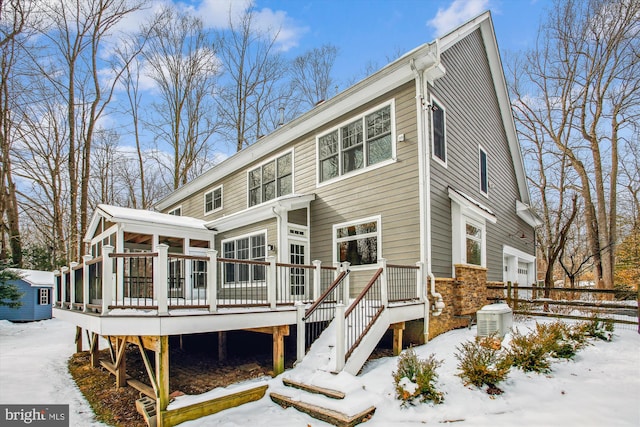 view of front facade with a sunroom and a wooden deck