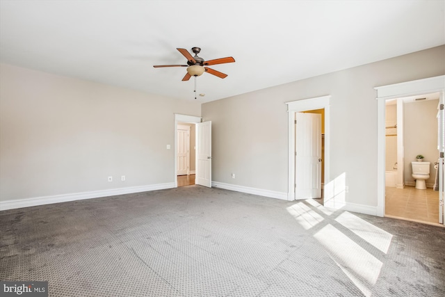 unfurnished bedroom with ensuite bathroom, carpet floors, and ceiling fan