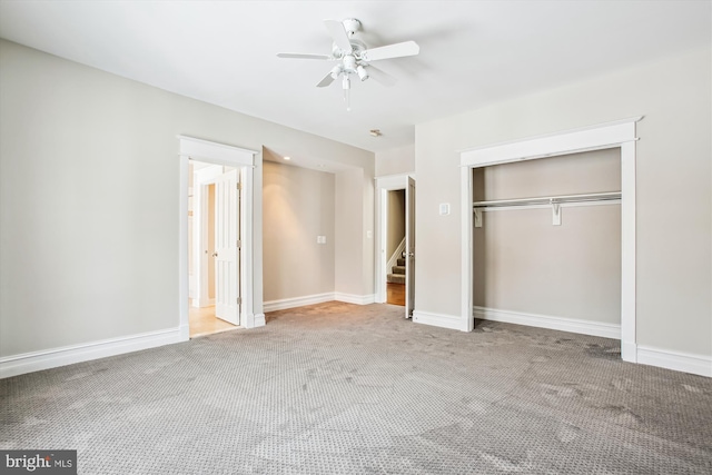 unfurnished bedroom with carpet floors, a closet, and ceiling fan