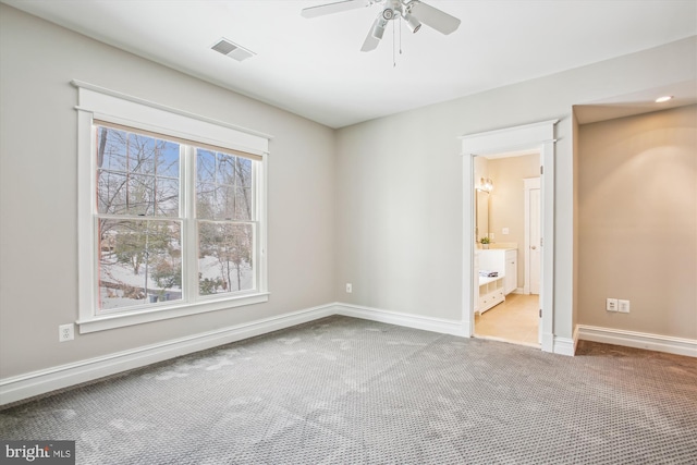 unfurnished bedroom with connected bathroom, ceiling fan, and carpet floors