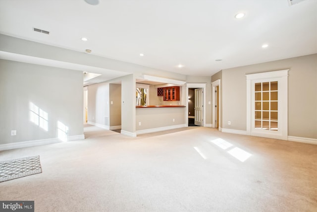 unfurnished living room with light carpet