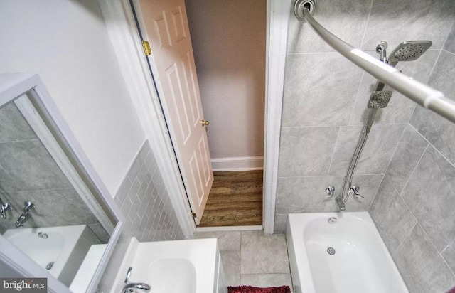 bathroom with wood-type flooring and tiled shower / bath combo