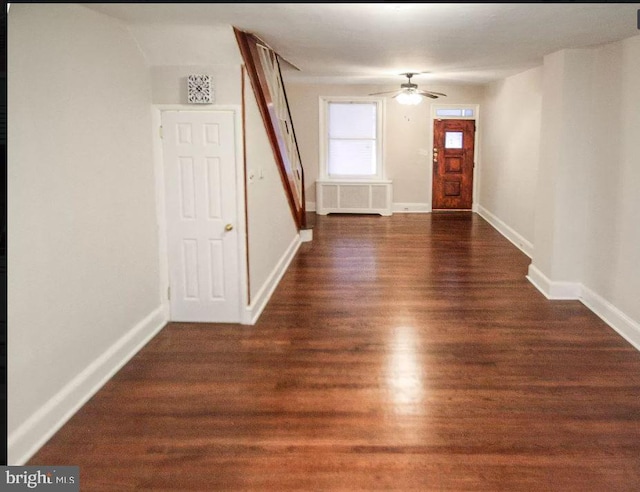 foyer featuring ceiling fan, radiator heating unit, and dark hardwood / wood-style floors