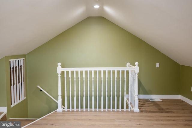 interior space with light hardwood / wood-style floors and vaulted ceiling