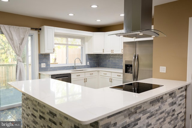 kitchen with sink, kitchen peninsula, island range hood, white cabinets, and appliances with stainless steel finishes