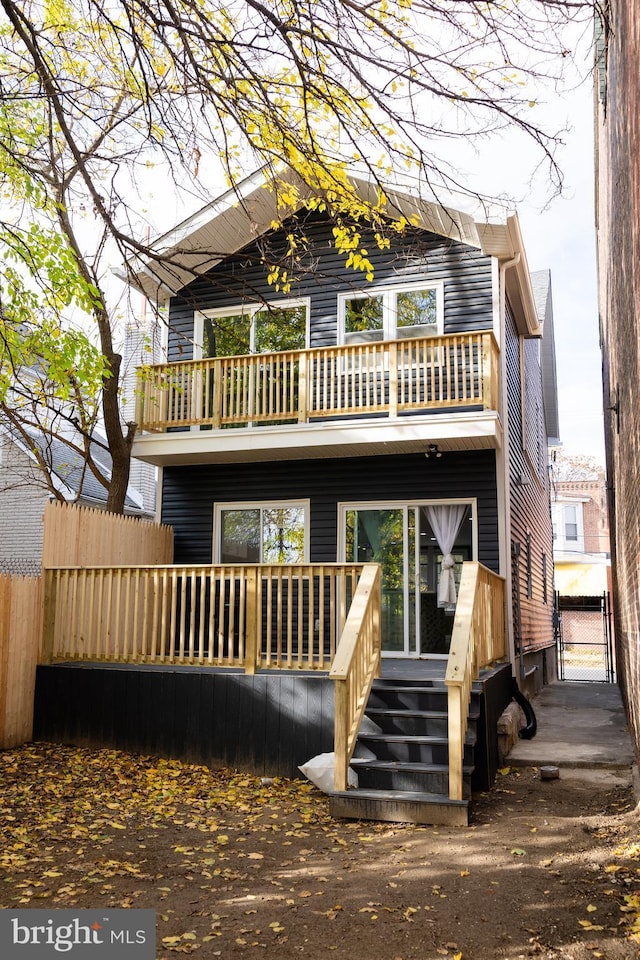 back of property with a balcony