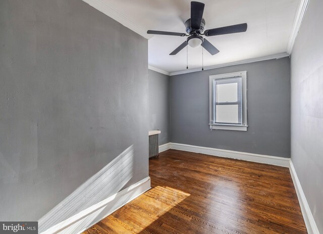 spare room featuring ceiling fan, crown molding, dark hardwood / wood-style flooring, and radiator heating unit