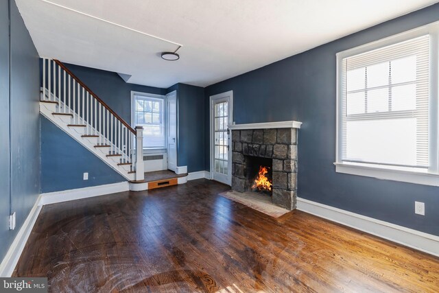 unfurnished living room featuring a fireplace and hardwood / wood-style flooring