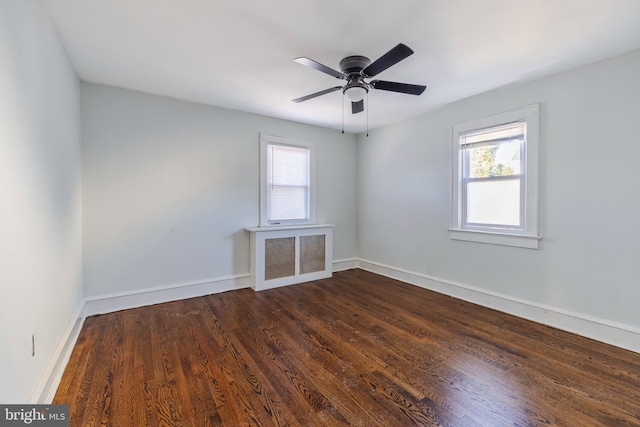 unfurnished room featuring dark hardwood / wood-style flooring, ceiling fan, and plenty of natural light