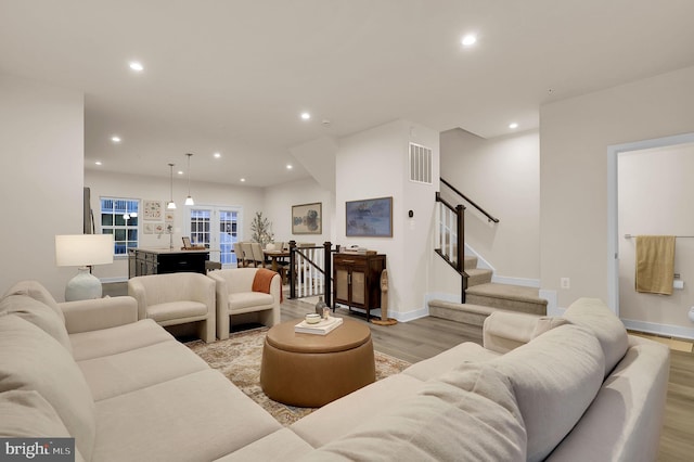 living room featuring light wood-type flooring and french doors