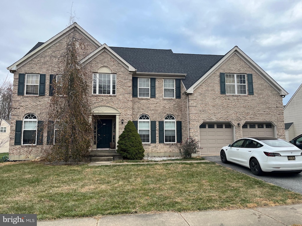 view of front of home featuring a garage and a front lawn