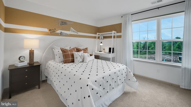 carpeted bedroom with multiple windows