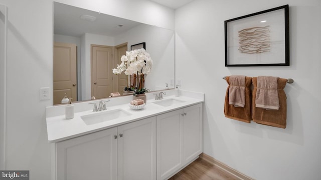 bathroom with vanity and wood-type flooring