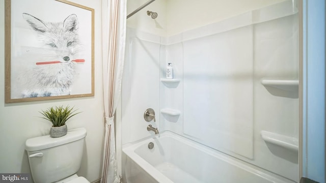 bathroom featuring shower / washtub combination and toilet