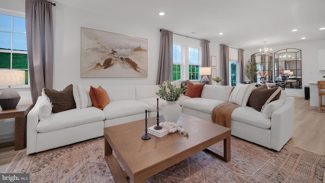 living room featuring light hardwood / wood-style floors and a notable chandelier