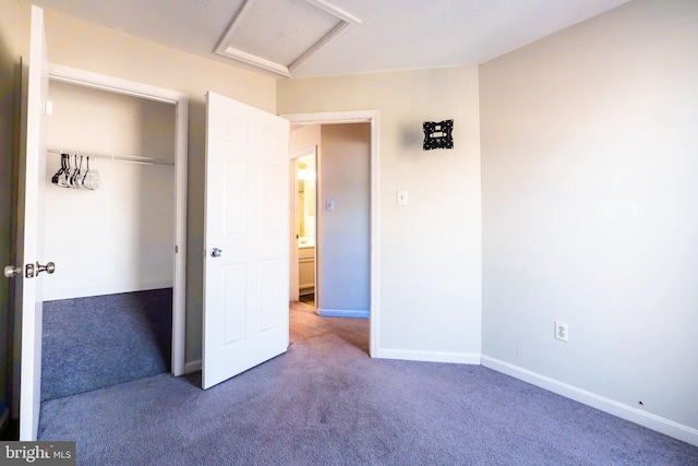 unfurnished bedroom featuring carpet and a closet