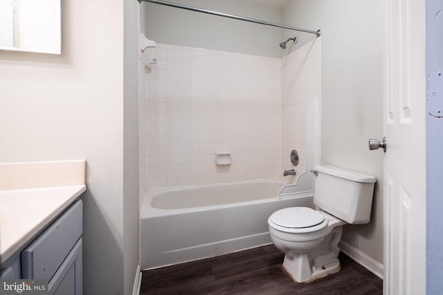 full bathroom with tiled shower / bath, vanity, toilet, and wood-type flooring