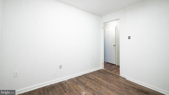 unfurnished room with dark hardwood / wood-style flooring