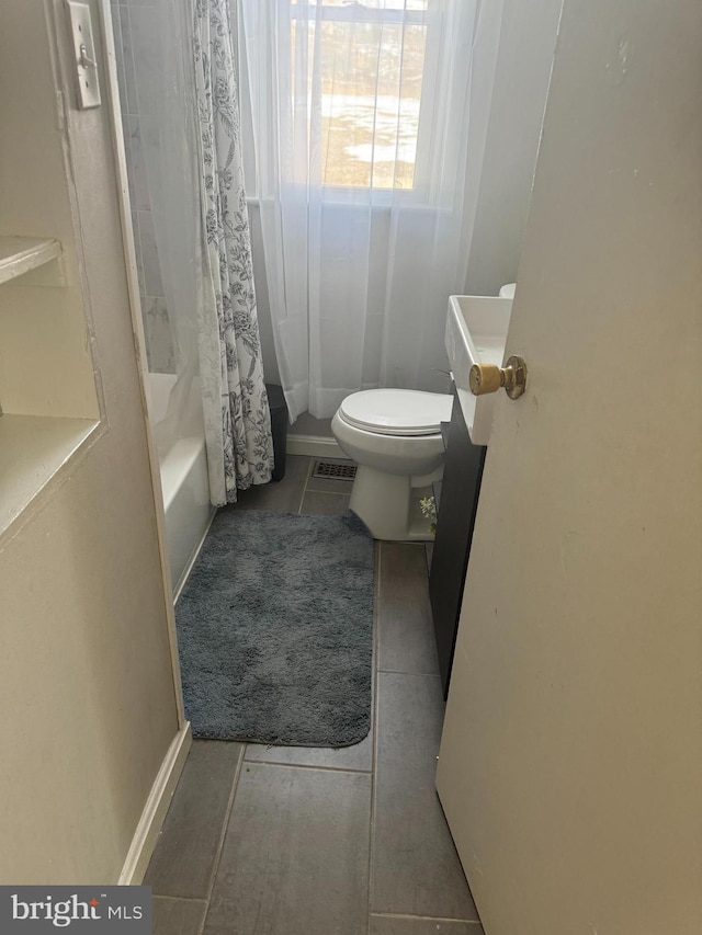 full bathroom featuring vanity, tile patterned flooring, shower / bath combination with curtain, and toilet