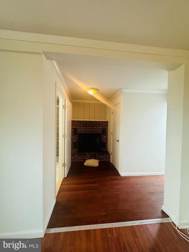 hallway with hardwood / wood-style flooring and crown molding