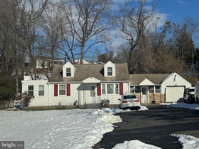 new england style home featuring a garage