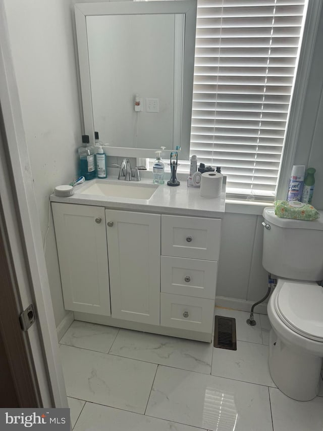 bathroom with vanity and toilet