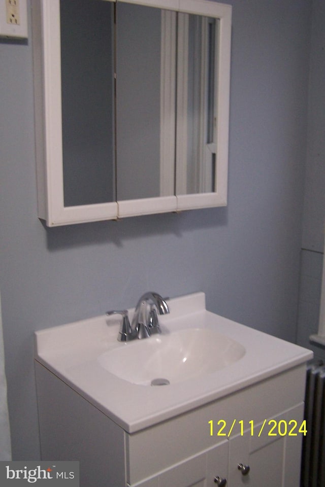 bathroom featuring vanity and radiator