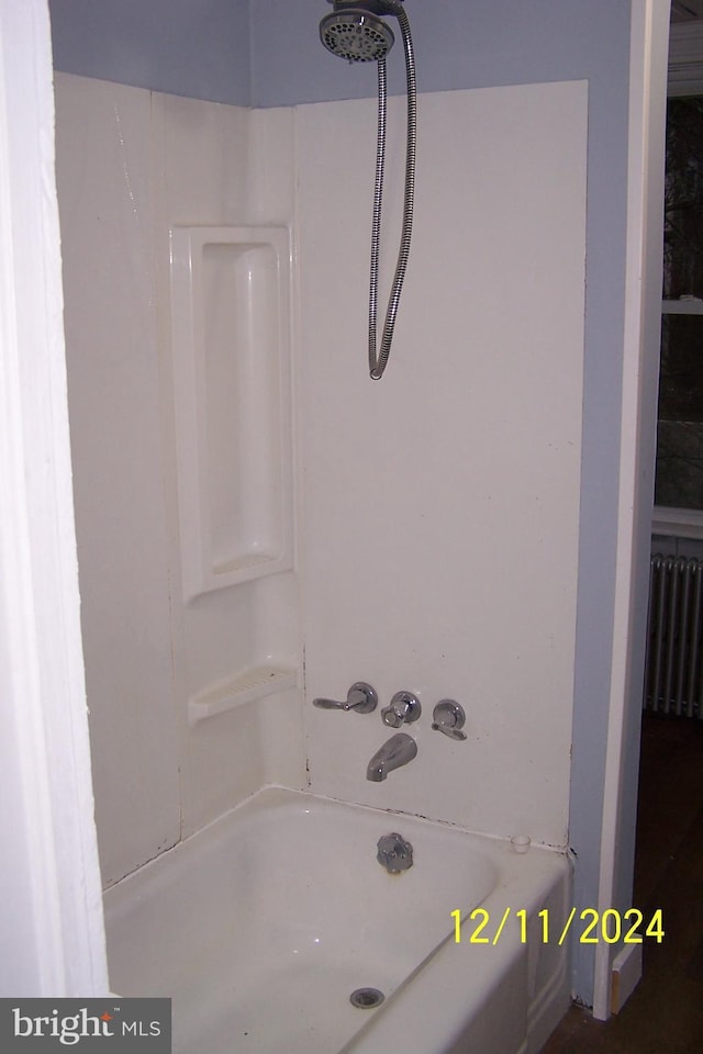 bathroom with radiator and  shower combination