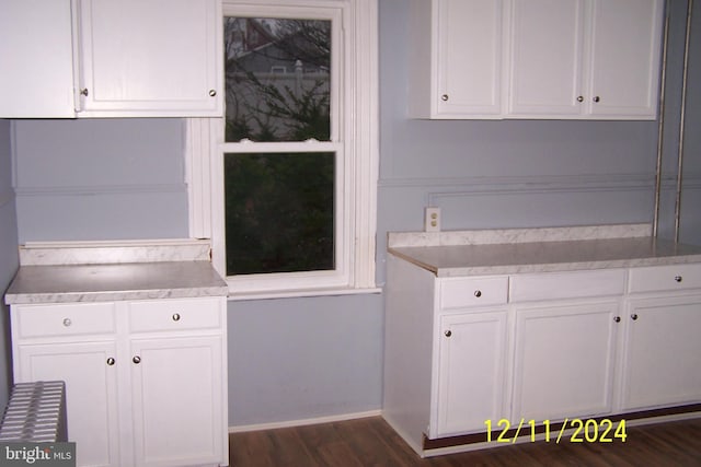 kitchen featuring white cabinets and dark hardwood / wood-style floors