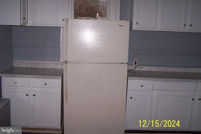303 W Patterson St, Lansford, PA 18232 - kitchen featuring freestanding refrigerator, white cabinetry, and radiator