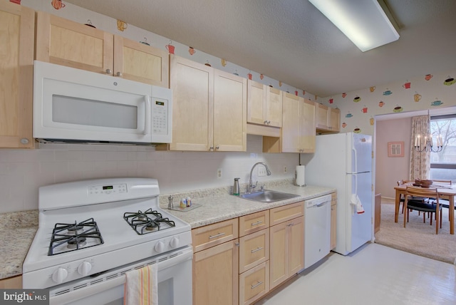 kitchen featuring sink, light colored carpet, white appliances, and light brown cabinets