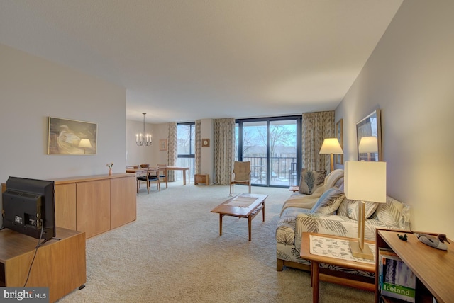 living room featuring light carpet and an inviting chandelier