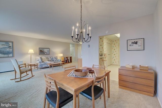 dining room with light carpet and a notable chandelier