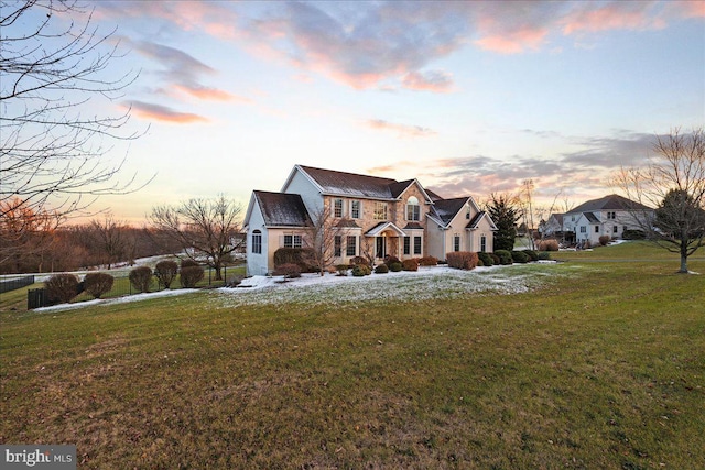 property exterior at dusk with a yard