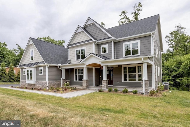 craftsman-style house with a porch, central AC, and a front lawn