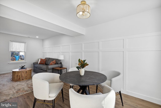 dining space featuring dark wood-type flooring and a notable chandelier