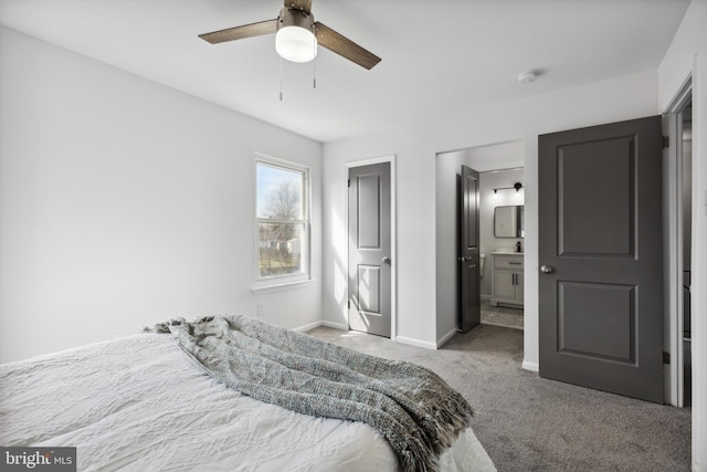 carpeted bedroom featuring ceiling fan and ensuite bath