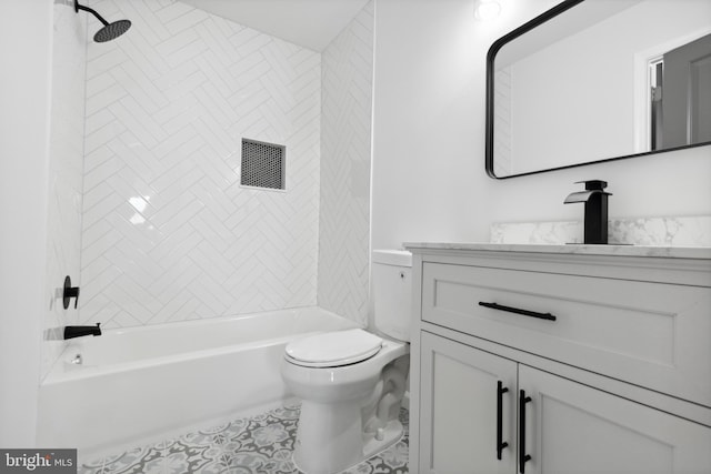 full bathroom featuring tile patterned flooring, tiled shower / bath combo, toilet, and vanity