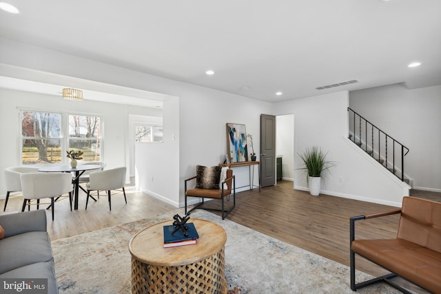 living room featuring a chandelier and hardwood / wood-style flooring