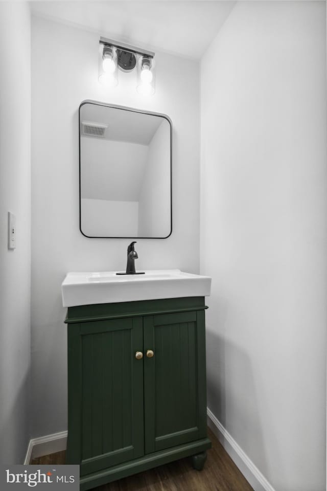 bathroom featuring vanity and wood-type flooring