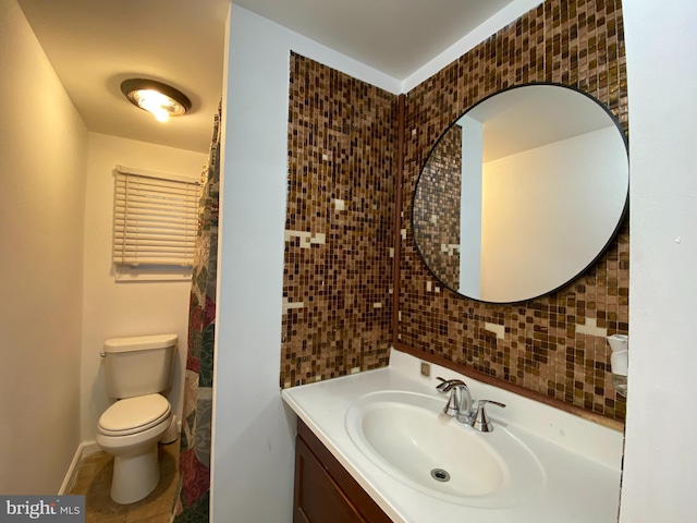 bathroom with decorative backsplash, vanity, and toilet